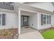 House entrance with gray door, white columns, and gray shutters at 121 Crossroad Dr. Nw, Calabash, SC 28467