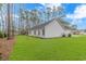 White house exterior with a dark gray roof, showcasing a side view at 121 Crossroad Dr. Nw, Calabash, SC 28467