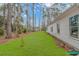 View of the home's exterior showcasing the side of the house with windows at 121 Crossroad Dr. Nw, Calabash, SC 28467