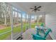 Screened porch with two teal chairs and a small table at 121 Crossroad Dr. Nw, Calabash, SC 28467