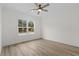 Spacious bedroom with large window and wood-look flooring at 127 Stonewall Circle # 6-4, Longs, SC 29568