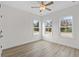 Spacious bedroom with wood-look floors and three windows at 127 Stonewall Circle # 6-4, Longs, SC 29568