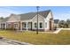 Craftsman style home with a light beige exterior, stone accents, and a covered porch at 127 Stonewall Circle # 6-4, Longs, SC 29568