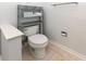 Small bathroom with toilet and shelving at 1392 Southwood Dr., Surfside Beach, SC 29575