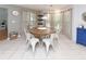 Bright dining room with a round wooden table and six white metal chairs at 1392 Southwood Dr., Surfside Beach, SC 29575