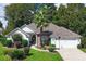 White one-story house with a brick facade, two-car garage, and palm tree in front at 1392 Southwood Dr., Surfside Beach, SC 29575