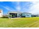 Manicured backyard featuring a screened-in porch and a spacious, green lawn at 1410 Saw Palmetto St., North Myrtle Beach, SC 29582