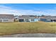 Home's backyard with screened porch overlooking pond at 1410 Saw Palmetto St., North Myrtle Beach, SC 29582