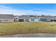 Expansive backyard featuring a pond view and the home's exterior with screened-in porch at 1410 Saw Palmetto St., North Myrtle Beach, SC 29582