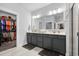 Double vanity bathroom with large mirrors and gray cabinets at 1410 Saw Palmetto St., North Myrtle Beach, SC 29582