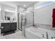 Modern bathroom with gray tiled walls, a soaking tub, and a glass-enclosed shower with sleek fixtures at 1410 Saw Palmetto St., North Myrtle Beach, SC 29582