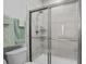 Bathroom featuring a glass-enclosed shower, modern fixtures, and decorative wall tiles, plus a commode at 1410 Saw Palmetto St., North Myrtle Beach, SC 29582