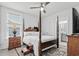 Charming bedroom featuring a poster bed, area rug, and access to the attached bathroom and walk-in closet at 1410 Saw Palmetto St., North Myrtle Beach, SC 29582