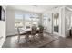 Bright dining room with ample natural light, stylish light fixture, and a view of the water at 1410 Saw Palmetto St., North Myrtle Beach, SC 29582