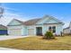 Charming light blue two-story house with a two car garage at 1410 Saw Palmetto St., North Myrtle Beach, SC 29582