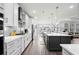 Open concept kitchen with white cabinets, stainless steel appliances, hardwood floors, and a center island at 1410 Saw Palmetto St., North Myrtle Beach, SC 29582