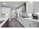 Modern kitchen featuring white cabinets, stainless steel appliances, hardwood floors and a grey kitchen island at 1410 Saw Palmetto St., North Myrtle Beach, SC 29582