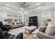 Comfortable living room featuring neutral tones, recessed lights, ceiling fan, and large windows at 1410 Saw Palmetto St., North Myrtle Beach, SC 29582