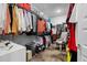 Well-organized walk-in closet with clothing racks, shelves, and storage bins, plus a decorative area rug at 1410 Saw Palmetto St., North Myrtle Beach, SC 29582