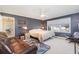 Bedroom with gray walls, window, and a leather couch at 1530 Deer Park Ln., Surfside Beach, SC 29575