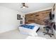 Bedroom with wood accent wall, bed, and workspace at 1530 Deer Park Ln., Surfside Beach, SC 29575