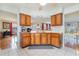 Kitchen with wood cabinets and a pass-through to the dining area at 1530 Deer Park Ln., Surfside Beach, SC 29575