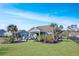 Landscaped backyard with spacious lawn and tropical plants at 1810 N Cove Ct., North Myrtle Beach, SC 29582