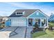 Front view of a charming two-story house with a driveway at 1810 N Cove Ct., North Myrtle Beach, SC 29582