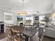 Open concept dining area with wood table and chairs, offering view to living room and bedroom at 1819 North Ocean Blvd. # 8015, North Myrtle Beach, SC 29582