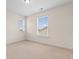 Well-lit bedroom with neutral carpet and two windows at 1901-B High St., Myrtle Beach, SC 29577