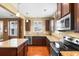 Well-equipped kitchen with granite countertops and dark wood cabinets at 1901-B High St., Myrtle Beach, SC 29577