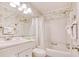 Clean bathroom with shower/tub combo, white vanity, and tropical wallpaper at 191 Maison Dr. # B206, Myrtle Beach, SC 29572