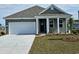 Charming one-story home with gray siding, white garage door, and landscaped lawn at 201 Black Pearl Way, Myrtle Beach, SC 29588