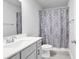 Clean bathroom with gray vanity, shower/tub combo, and patterned curtain at 206 Calhoun Falls Dr., Myrtle Beach, SC 29579