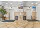 Hallway view of elevators with tile flooring and beach-themed decorations at 210 75Th Ave N # 4010, Myrtle Beach, SC 29572