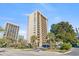 Modern high-rise condo building featuring private balconies and lush landscaping at 210 75Th Ave N # 4010, Myrtle Beach, SC 29572