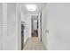 View from the kitchen with white cabinets and marble countertops and opening into the bedroom at 210 75Th Ave N # 4010, Myrtle Beach, SC 29572