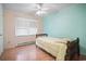 Cozy bedroom featuring paneled walls and a wooden framed single bed, bathed in natural light at 2102 Calabash Circle, Little River, SC 29566
