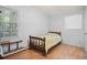 Modest bedroom with a wooden framed single bed, next to a bright window at 2102 Calabash Circle, Little River, SC 29566