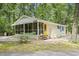 Charming home featuring a screened porch, complemented by lush greenery at 2102 Calabash Circle, Little River, SC 29566