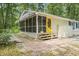 Charming home with a screened porch, yellow door, and quaint garden space at 2102 Calabash Circle, Little River, SC 29566