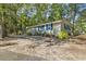 Cute seaside cottage with blue shutters and lovely landscaping at 2102 Calabash Circle, Little River, SC 29566