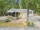 Charming home featuring a screened-in porch, yellow front door, and well-maintained landscaping at 2102 Calabash Circle, Little River, SC 29566