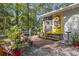 Brick patio with colorful plants and yellow door at 2102 Calabash Circle, Little River, SC 29566