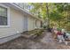 Tan house exterior with wooden deck, gray door, and surrounding trees at 2102 Calabash Circle, Little River, SC 29566