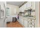 Bright kitchen with white cabinets and wood flooring at 2102 Calabash Circle, Little River, SC 29566