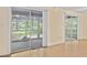 Bright living room featuring seamless access to a screened porch with nature views at 2102 Calabash Circle, Little River, SC 29566
