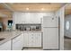 Kitchen corner with white cabinets, granite counters, and appliances at 2102 S Ocean Blvd. # D, North Myrtle Beach, SC 29582