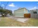 Green house exterior with a wooden gate and ample parking area at 2102 S Ocean Blvd. # D, North Myrtle Beach, SC 29582