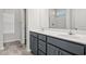 Double vanity bathroom with gray cabinets and a shower at 245 Six Mile Creek Dr., Georgetown, SC 29440